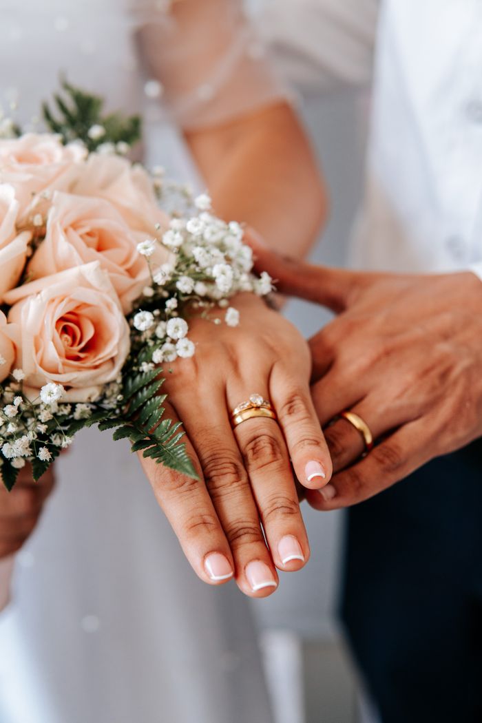 creative-01 A beautiful display of wedding rings alongside a delicate bouquet symbolizes love and union.